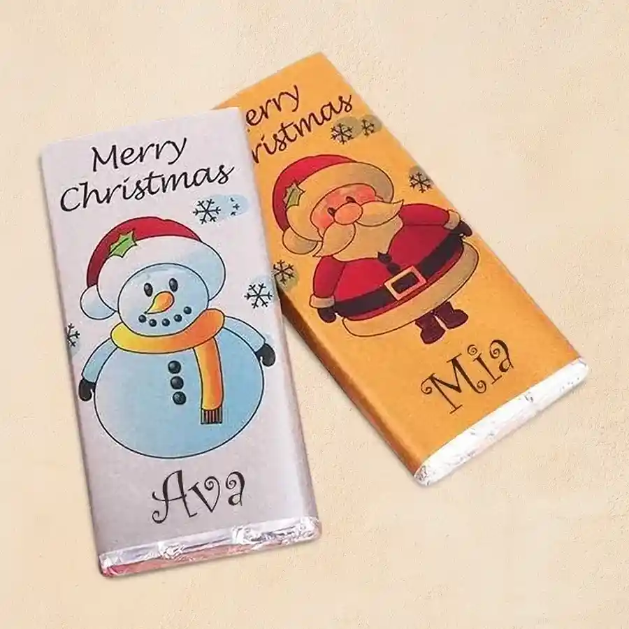 Two personalized Cadbury Dairy Milk chocolate bars with festive Christmas decorations and a customizable message.