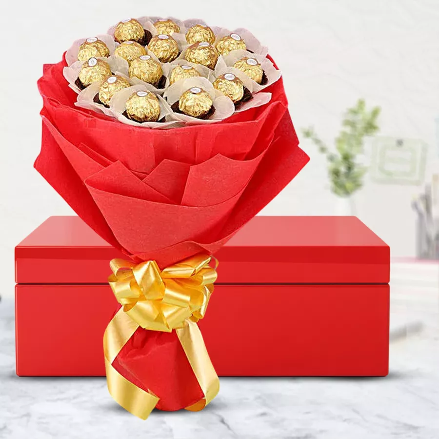 Marvelous Box Arrangement of Ferrero Rocher Chocolate with 16 chocolates in vibrant red tissue and a golden bow in a sleek red folding box
