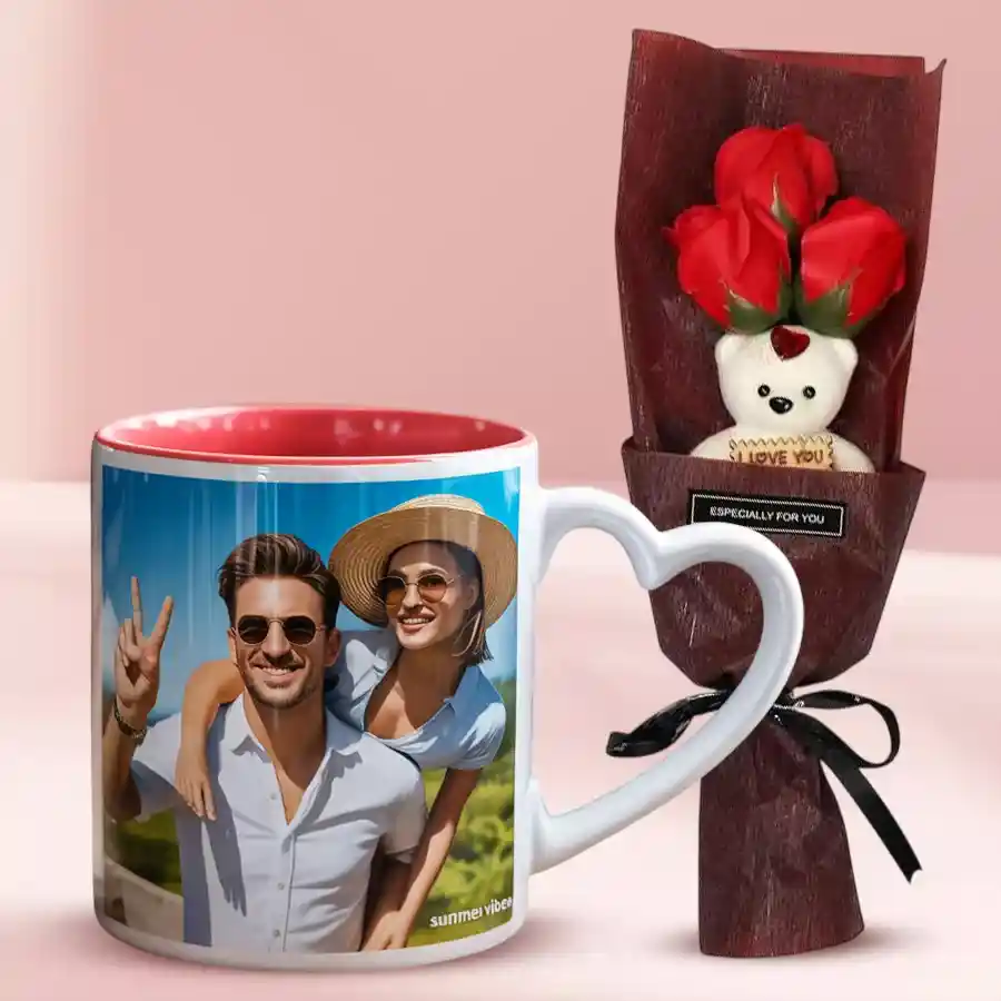 Artificial roses bouquet, a teddy bear, and a personalized coffee mug with a heart handle arranged as a Valentine's Day gift.