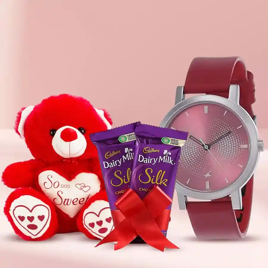Ladies watch gift set featuring a stylish analog watch, a singing teddy bear, and two Cadbury Silk chocolates tied with a red ribbon.