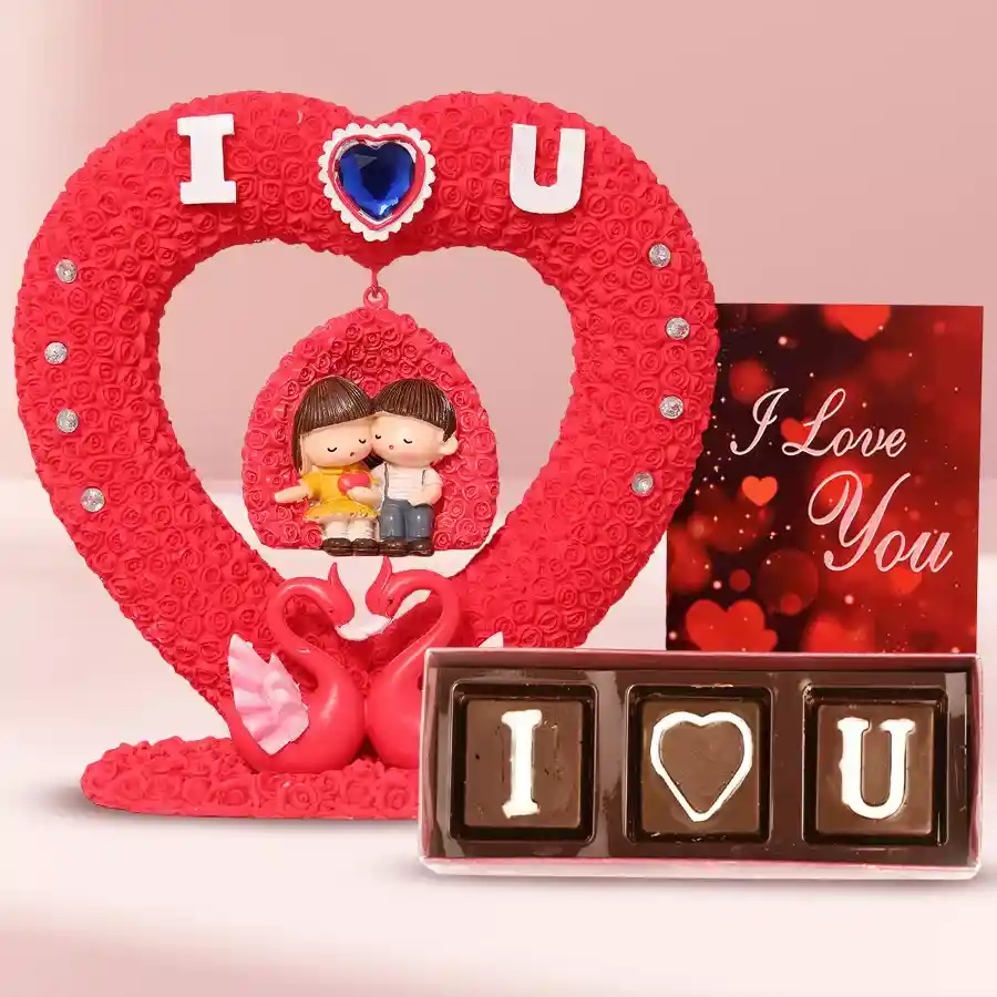 Romantic couple statue, handcrafted chocolates, and musical greetings card combo for Valentine's Day gift.