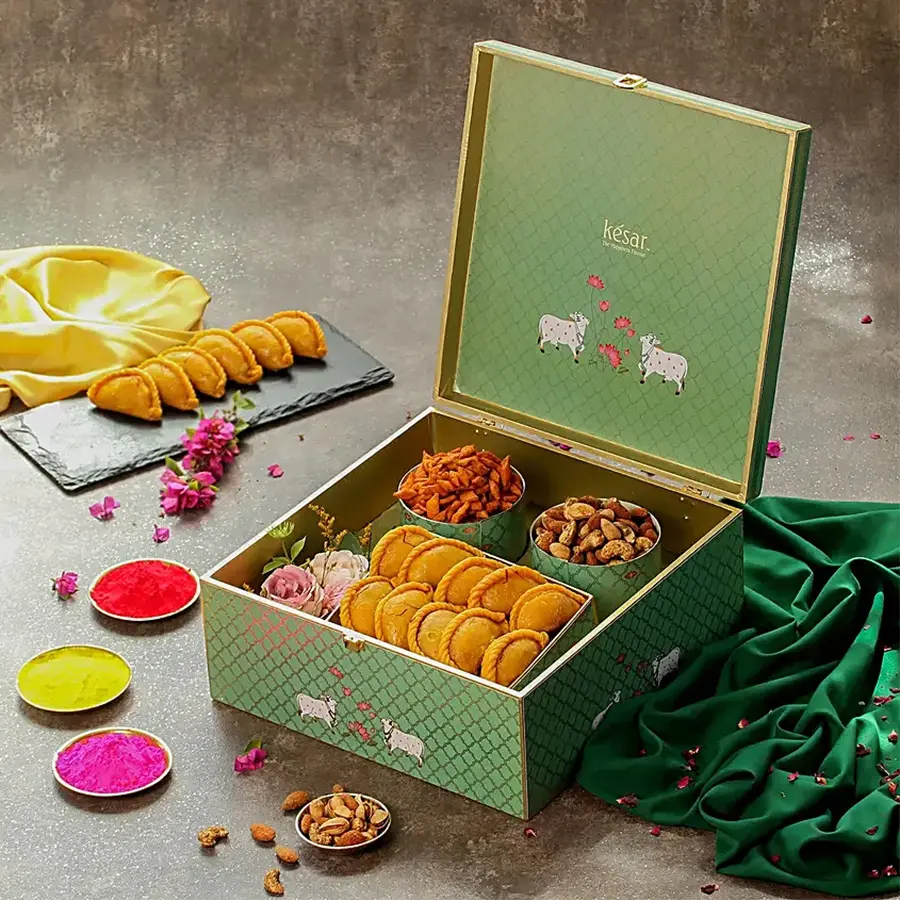 Yummy Sweets N Crunchy Holi Treat Gift Box with Kesar Gujiya, Mix Nuts, Chilli Namkeen, and a Holi Greetings Card in a premium box