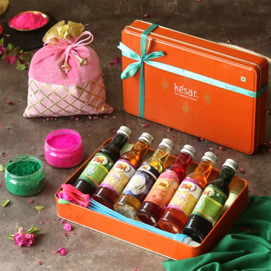 Flavorous Mini Sharbat Gift Hamper with colorful herbal gulal, water balloon, and Holi greetings card