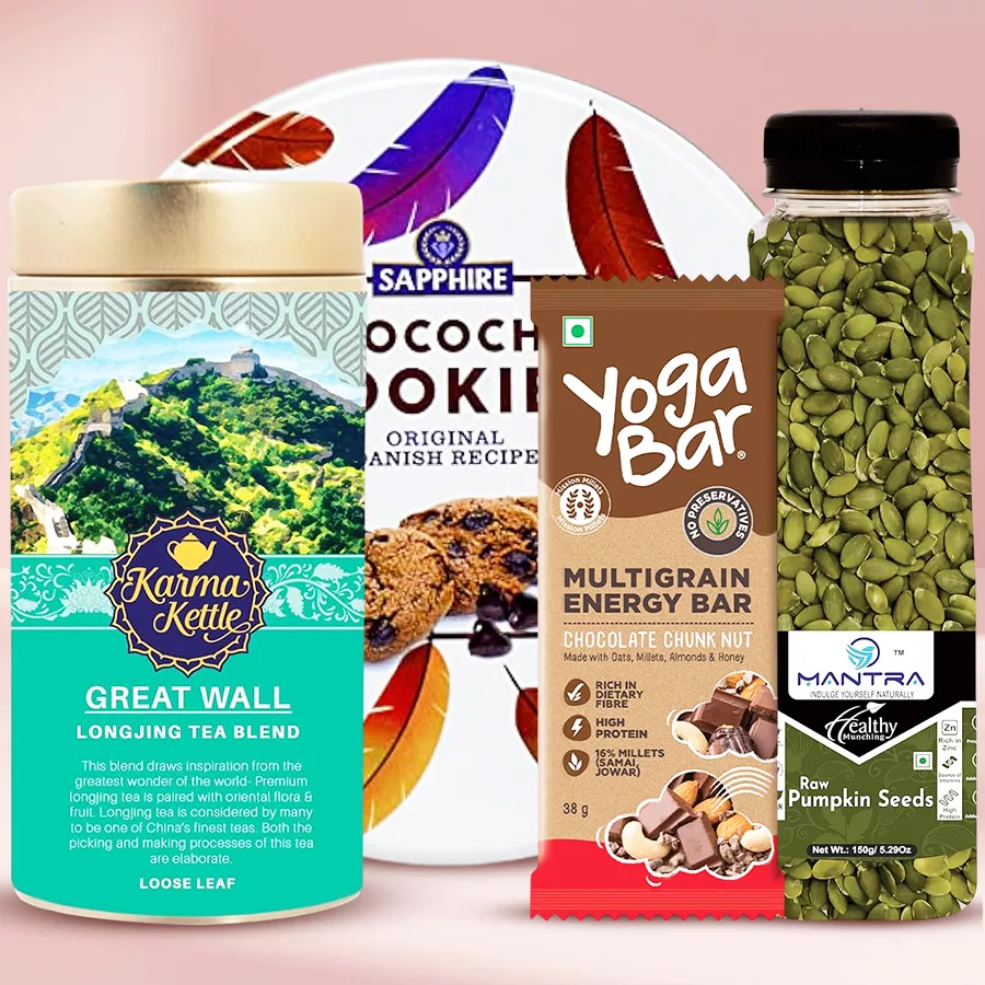 Healthy Tea Time Goodies Combo featuring tea, cookies, a snack bar, and pumpkin seeds arranged beautifully for a delightful presentation.