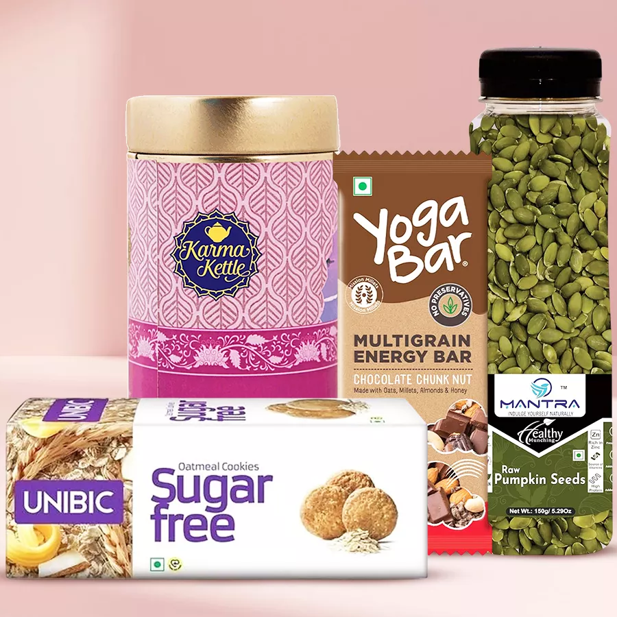Aromatic Gulmarg Tea Gift Hamper featuring Karma Kettle Tea, Unibic Cookies, Yoga Bar, and Mantra Raw Chia Seeds arranged in an appealing display.