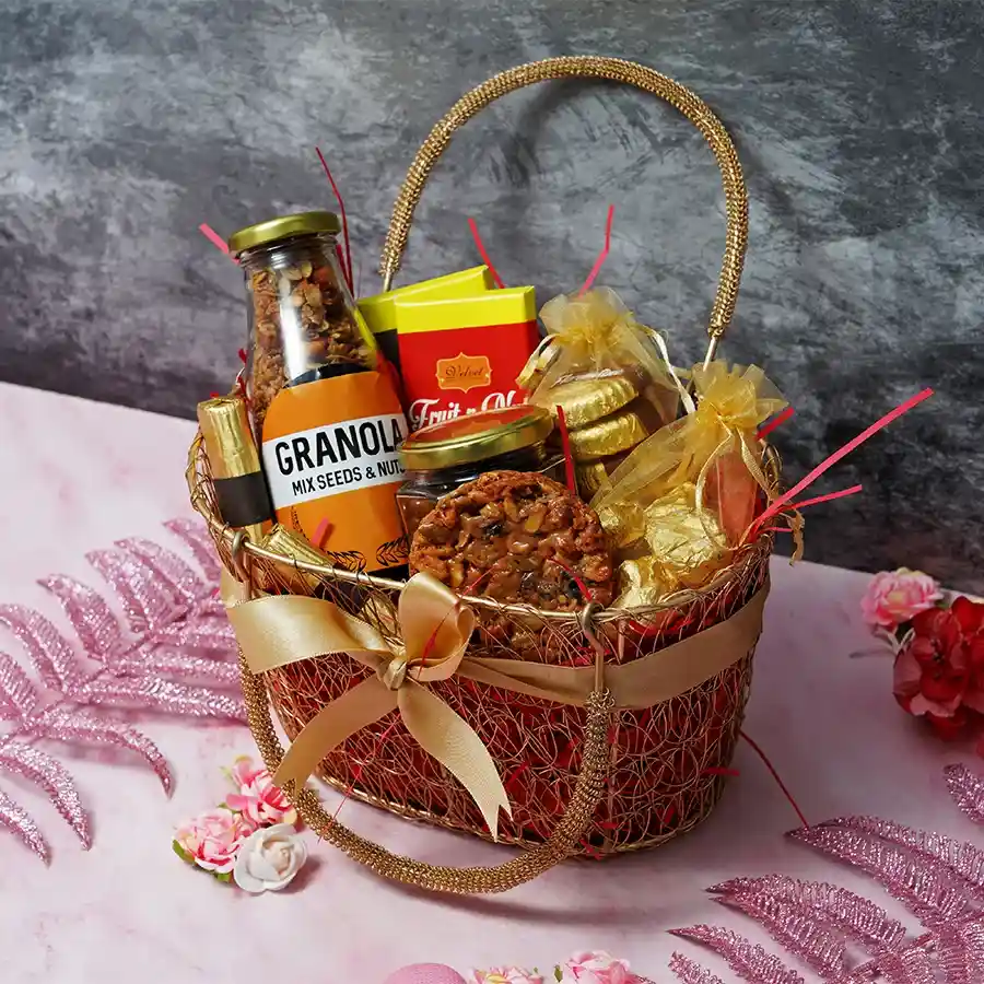 Gourmet Chocolate Delight Basket filled with chocolate bars, almond florentines, chocolate-coated raisins, chocolate logs, crunchy chocolate almond rocks, and granola, arranged in a charming basket.