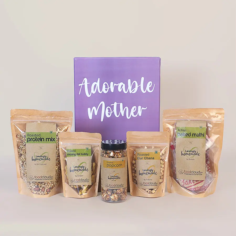 Flavorsome Munches Mother's Day Treat Hamper filled with various snacks including Roasted Protein Mix, Baked Mathi, Roasted Gur Chana, Caramel Popcorn, and Baked Moong Dal Twisty