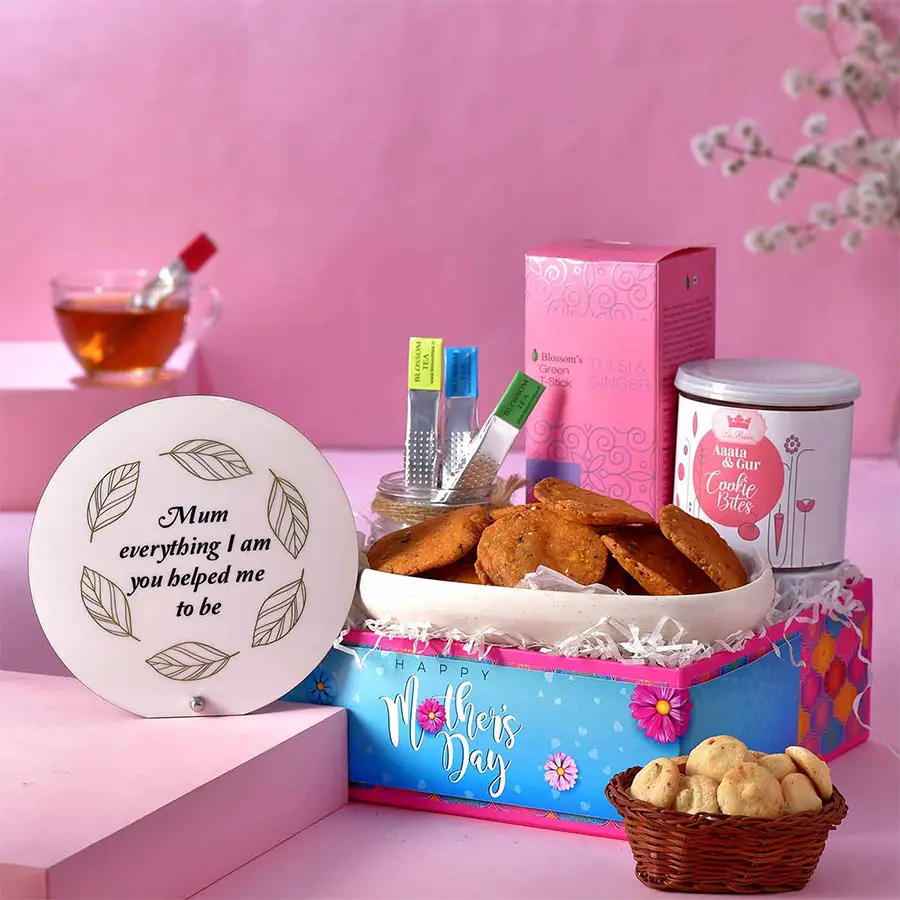 Refreshing Mothers Tea Time Hamper featuring MOM acrylic memento, Chai Puri, La Reine Aata N Gur cookies, Blossom Tulsi & Ginger green tea infusers, presented on a designer-crafted tray.