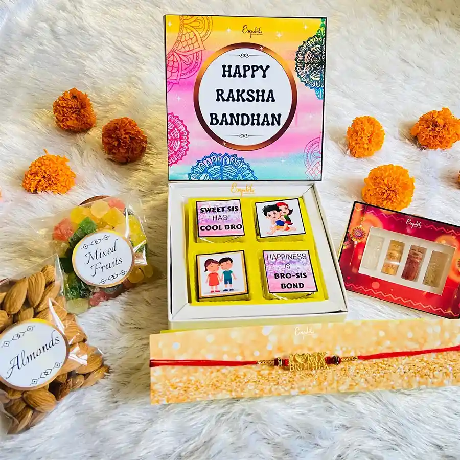 Exclusive Rakhi N Sweet Surprises Combo featuring a red metal rakhi with beads, assorted chocolates, almonds, dried fruits, Roli Tikka set, and a heartfelt greeting card.