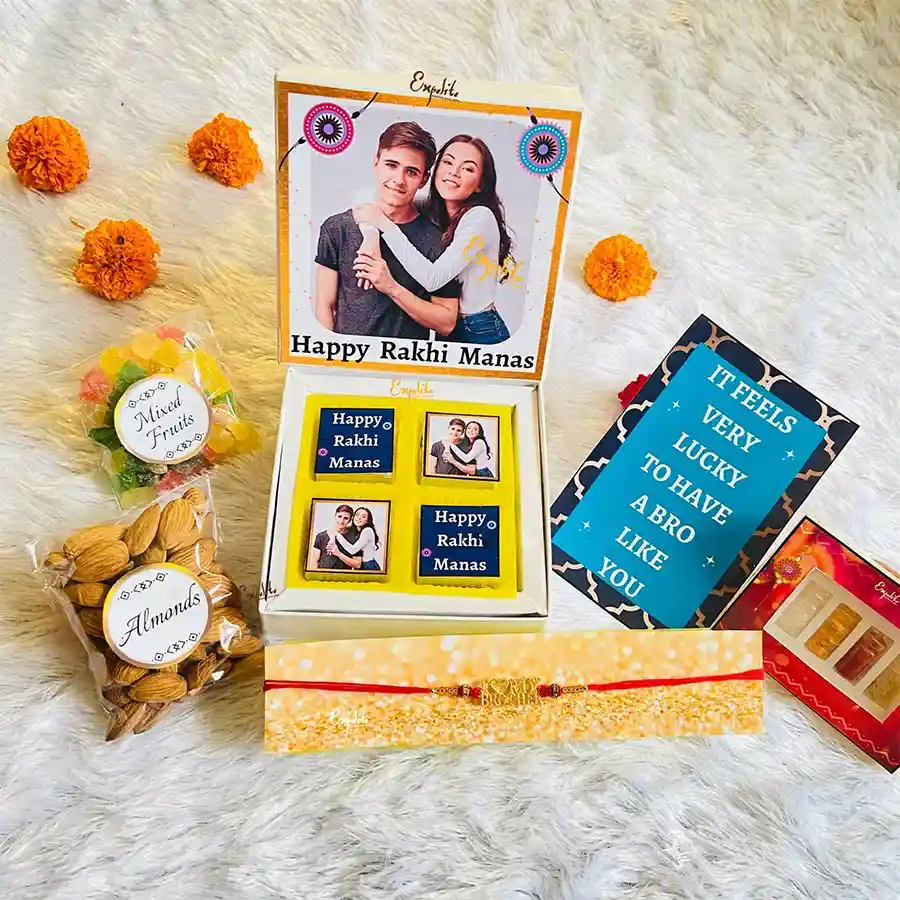 Wonderful Rakhi N Chocolates Personalize Hamper featuring a premium red mauli thread rakhi, assorted chocolates, almonds, mixed fruits, traditional items, and a greeting card.