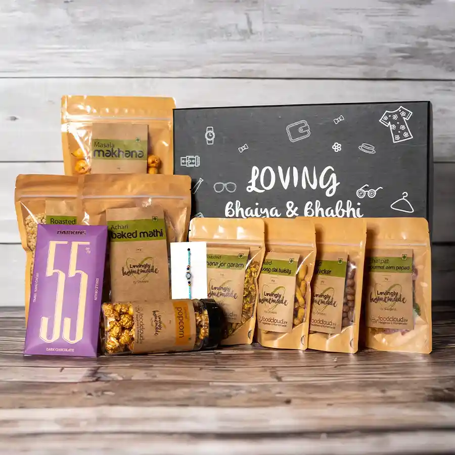 Crunchiest Bhaiya Bhabhi Tea Time Snack Pack featuring roasted makhana, caramel popcorn, chocolate slabs, and an Evil Eye Rakhi on a festive background.