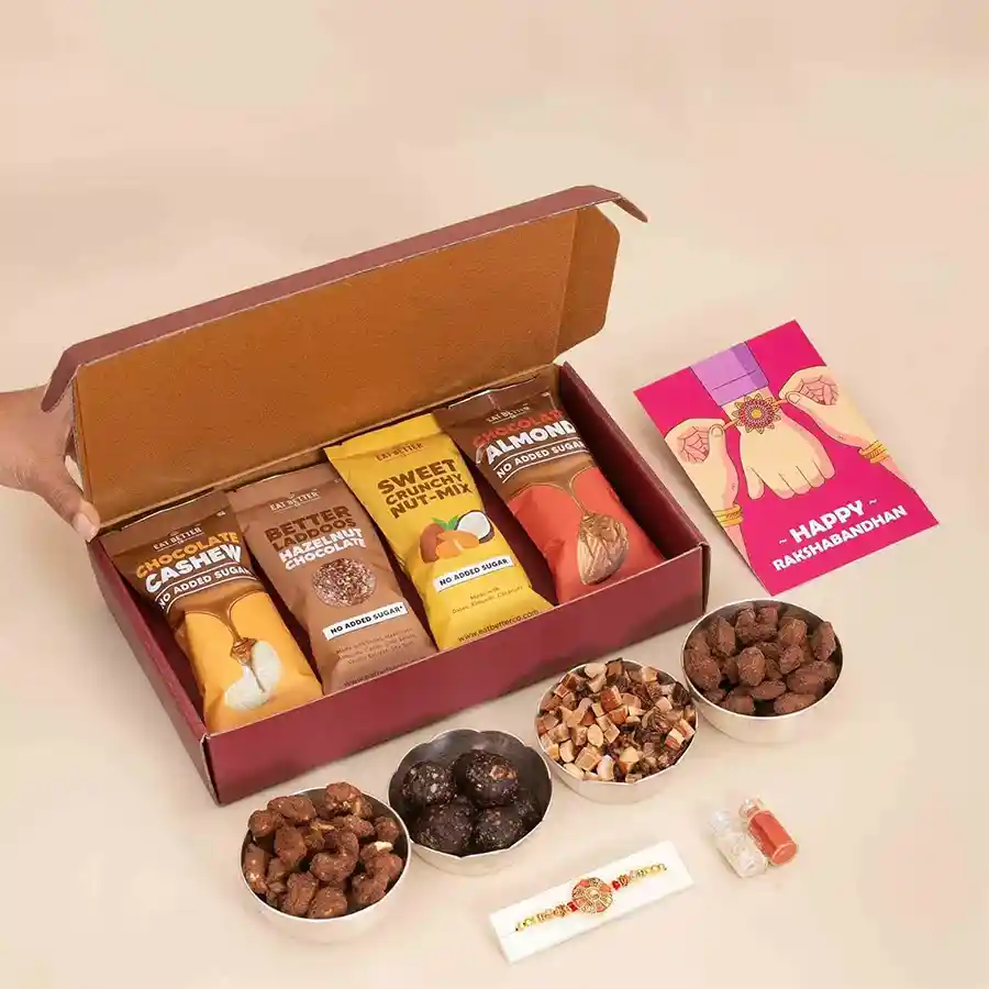Mouthful Magics for Brother Rakhi gift box featuring a designer rakhi made of stone and beads, surrounded by dry fruits and chocolates, with complimentary Roli, Tilak, and Chawal included.