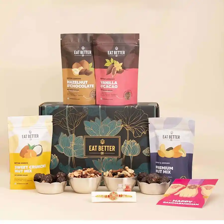 Health Blessings Nutty Choco Bhaiya Gift set featuring a handcrafted rakhi, a decorated box with golden roses, protein-packed laddoos, nut mixes, Roli, Tika, Chawal, and a greeting card