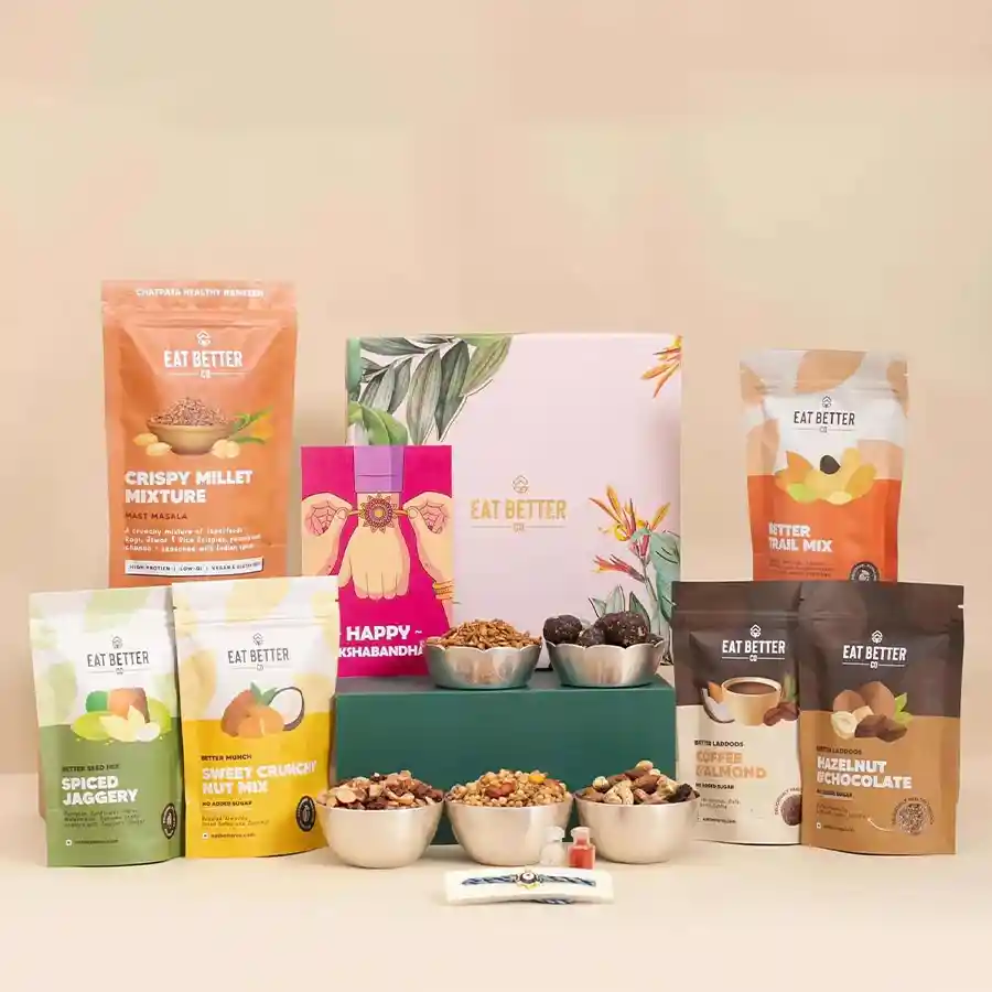 Mind Blowing Rakhshabandhan Besties gift hamper featuring an Evil Eye Rakhi, vegan and gluten-free snacks, Roli, Tilak, and Chawal in a gold-foiled box