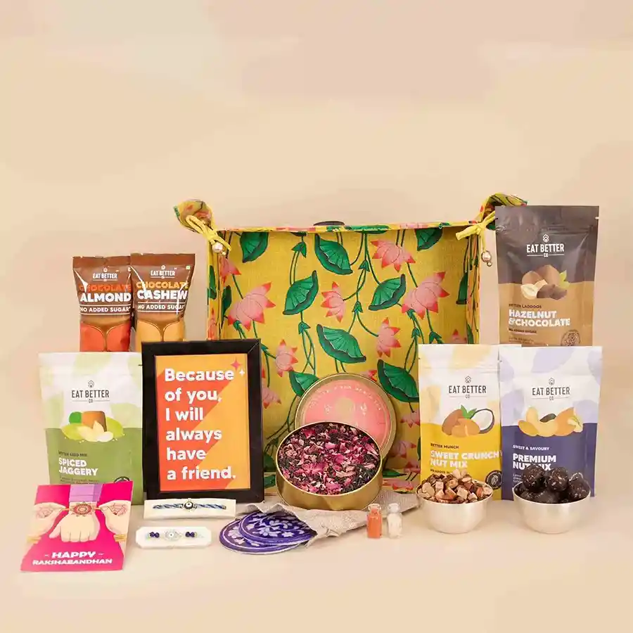 Star Maker Bhaiya Bhabhi Rakhi Set featuring an Evil Eye Rakhi, a unique bracelet, a greeting card, a photo frame, vegan snacks, blue pottery coasters, and a reusable Pichwai art tray.