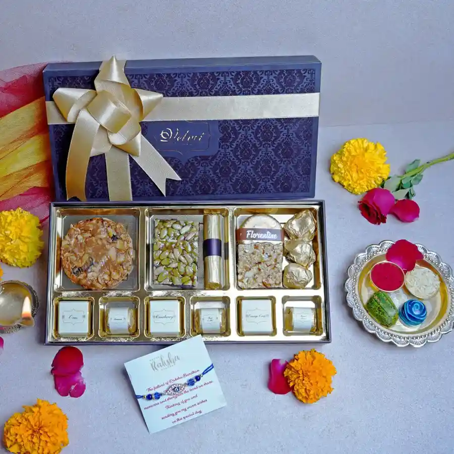 Rakhi Special Box containing gourmet chocolates, crunchy nuts, Florentine cookies, chocolate almonds, a stylish designer Rakhi, and a heartfelt greeting card, all beautifully packaged.