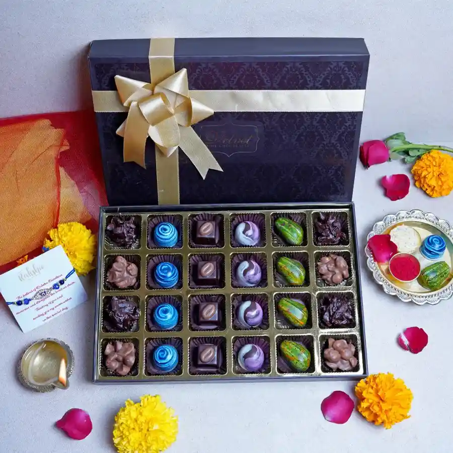 Chocolate Blast Box containing 24 assorted chocolates, a designer Rakhi, and a greeting card, all elegantly packaged in a decorative box.