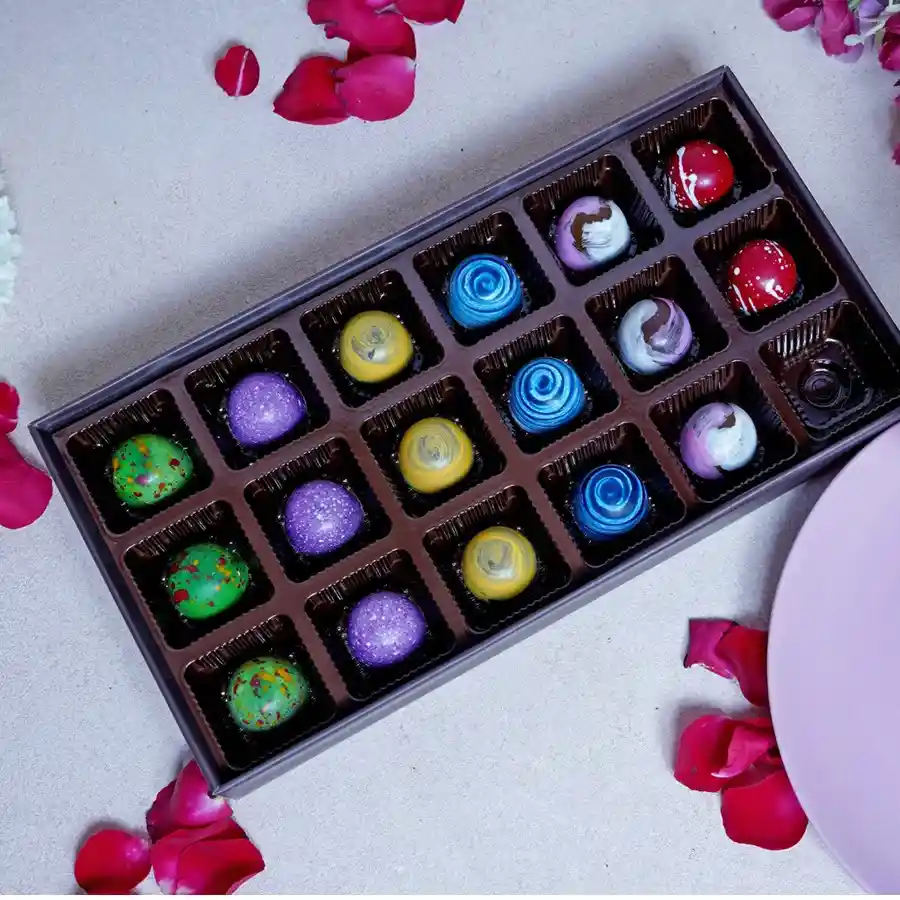 Bon Bon Celebration Box featuring 18 assorted chocolates, a designer Rakhi, and a heartfelt greeting card for Raksha Bandhan.