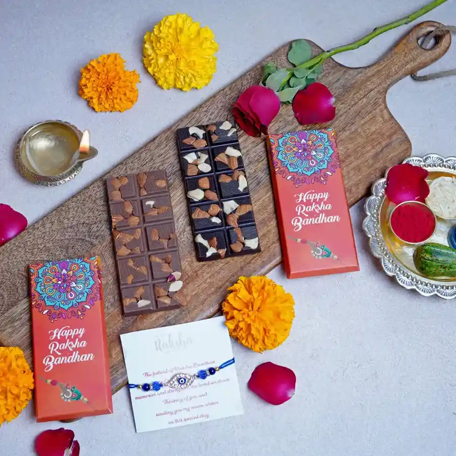 Awesome Rakhi Chocolate Bars gift box featuring roasted almond and fruit & nut chocolate bars, a stylish designer Rakhi, and a heartfelt greeting card