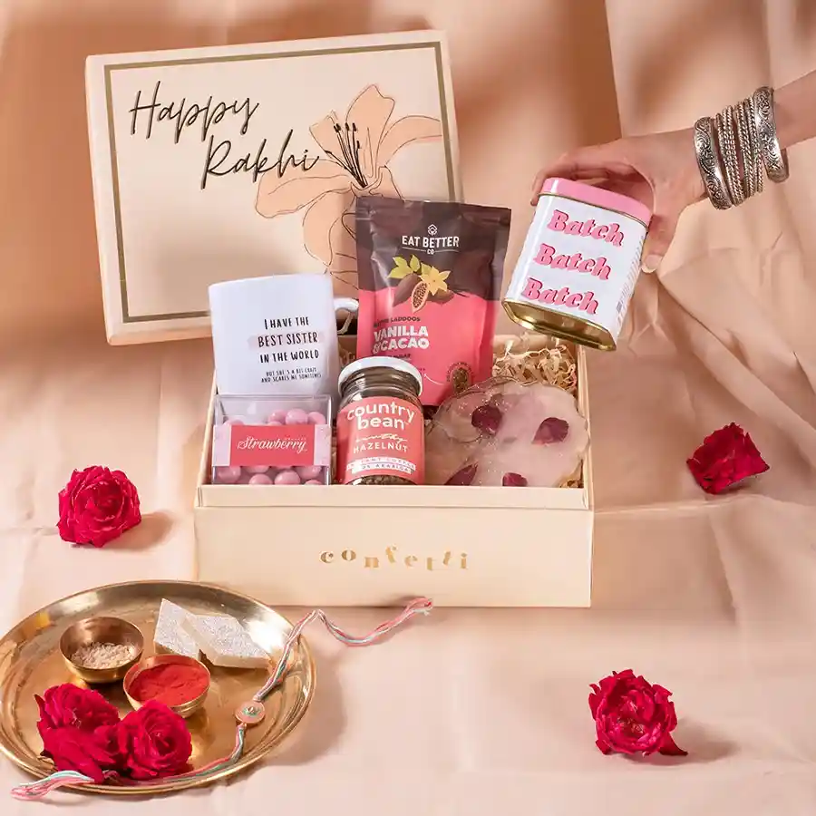 Gourmet Rakhi Hamper featuring chocolate, cookies, coasters, coffee, dragees, and a mug, all presented in a decorative box.
