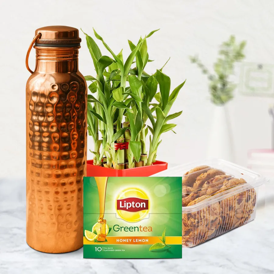 Perfect Rejuvenating Retirement Gift Set featuring a hammered copper bottle, a two-tier lucky bamboo plant, dry fruit cookies, and a green tea diffuser with tea bags