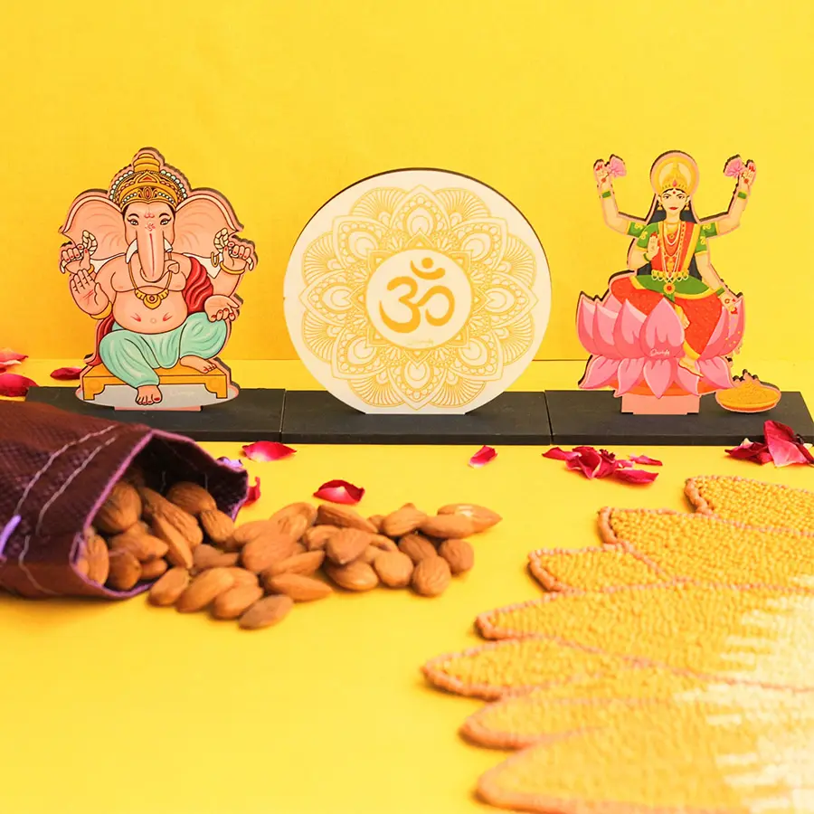 Divine Diwali Blessings Gift Set featuring handcrafted idols of Om, Ganeshji, and Laxmi Ji alongside a potli of premium almonds