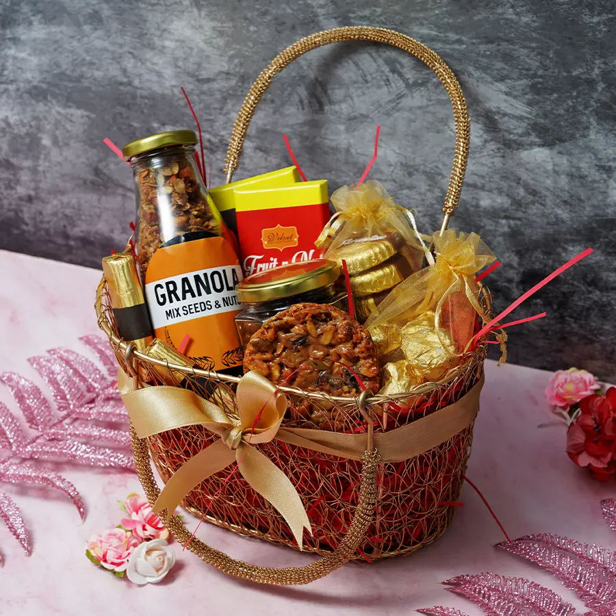 An assortment of gourmet cookies and treats including chocolate bars, nutterscotch, Florentines, almond chocolate rocks, granola logs, and a granola bottle arranged in an elegant display.
