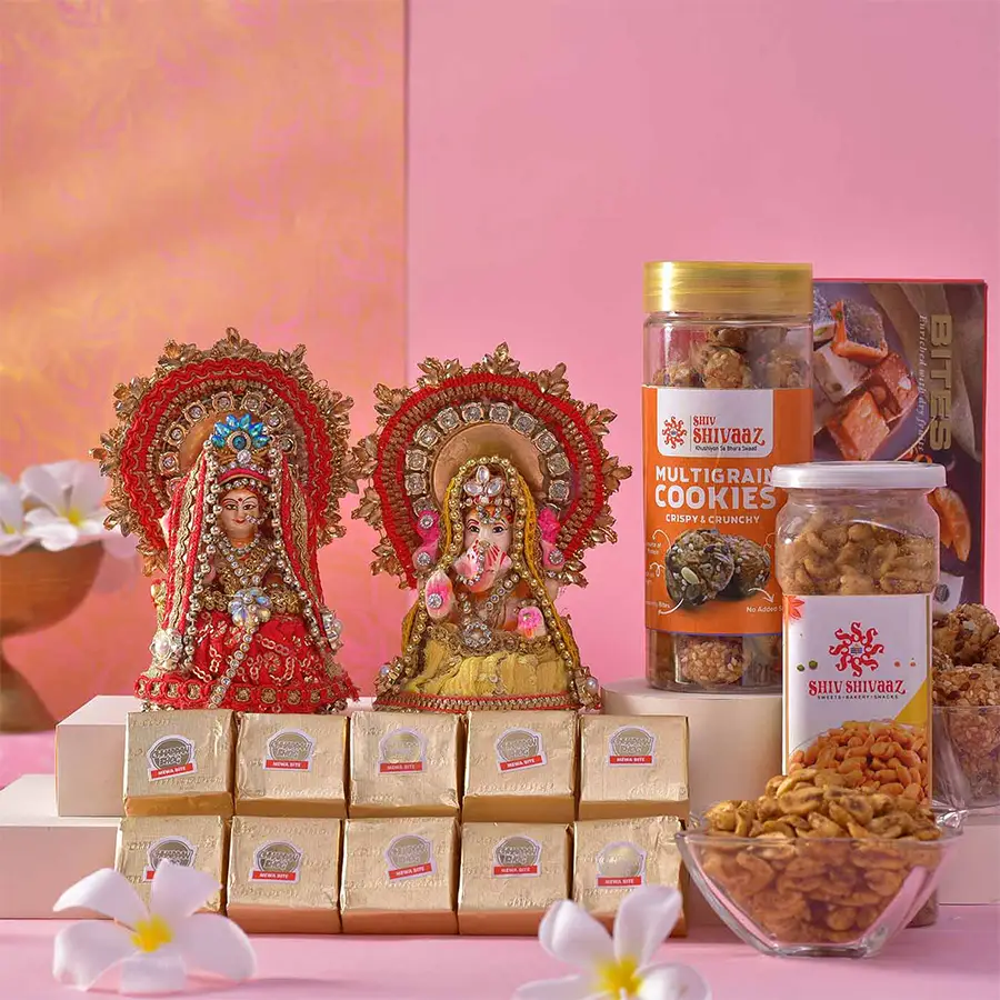 Festive Treasures Laxmi Ganesh N Mewa Bites hamper featuring clay idols, assorted mewa bites, masala peanuts, and multigrain cookies, beautifully arranged for Diwali celebration.