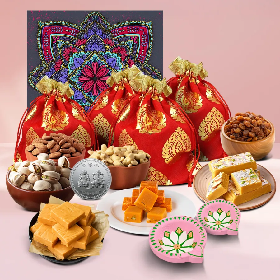 Diwali Nut Medley gift box featuring cashews, almonds, pistachios, raisins, fudge bites, clay diyas, and a silver-plated Ganesh Lakshmi coin in a festive mandala box