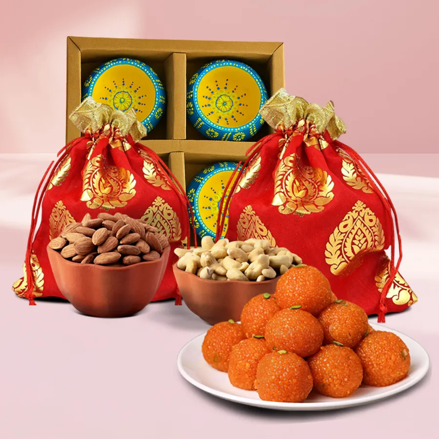 Premium Nutty n Chocolaty Treats gift box featuring 100g of cashews, 100g of almonds, 200g of motichoor ladoos, and 4 clay diyas on a festive background.