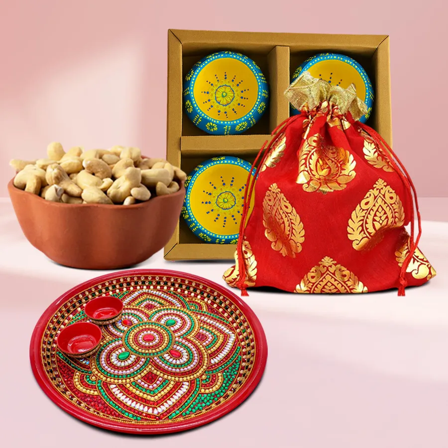 Pious Elegance Diwali Gift Hamper featuring a Designer Diwali Pooja Thali, four Designer Clay Diyas, and a potli of premium cashews