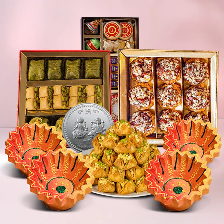 Exquisite Diwali Medley Hamper featuring Baklawa, handmade chocolates, Ganesh Lakshmi coin, and designer clay diyas on a festive background.