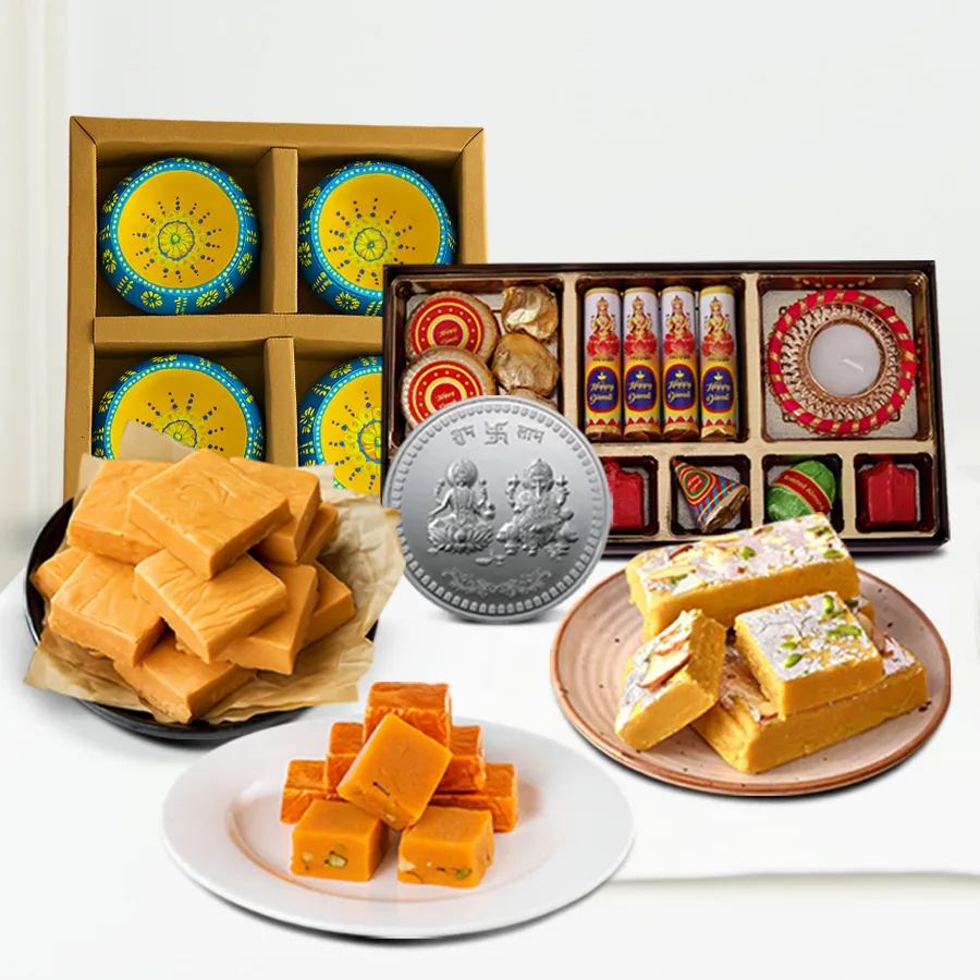 Assorted Festive Opulence Hamper featuring Mewa, Orange, and Butterscotch Fudge Bites, handmade chocolate crackers, a silver-plated Ganesh Lakshmi coin, and clay diyas.