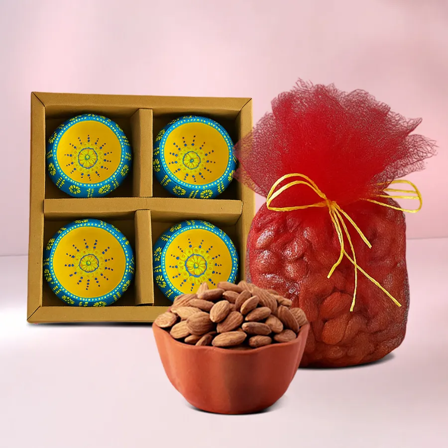 Celebration Chronicles Hamper featuring crunchy almonds in a net potli and four handcrafted clay diyas for Diwali celebrations