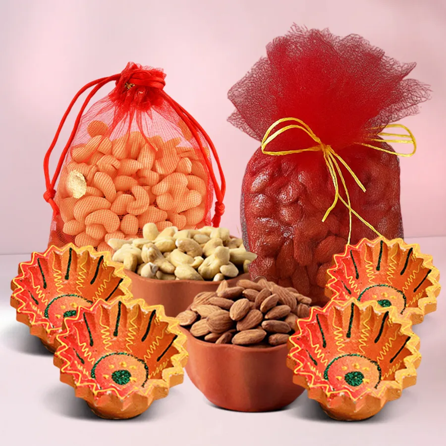 A beautifully arranged Diwali gift hamper featuring 250g each of premium cashews and almonds in elegant net potlis, accompanied by four handcrafted clay diyas, symbolizing the festive spirit of Diwali.
