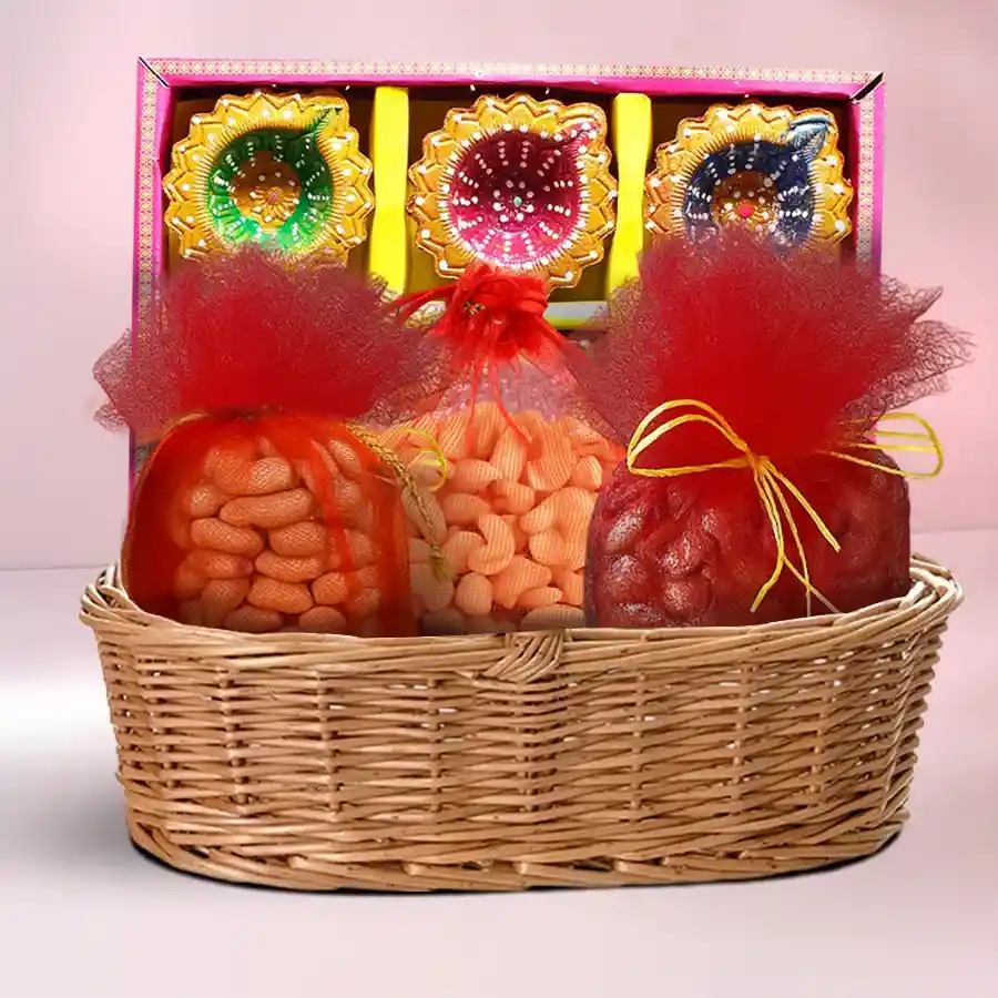 Enchanting Diwali Elegance Hamper featuring premium nuts in stylish potlis, clay diyas, and a designer cane basket