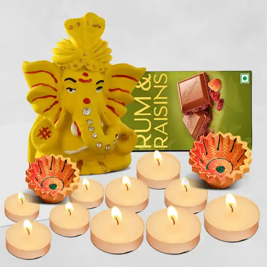 Diwali Lights and Chocolate Hamper featuring a Ganesh idol, Cadbury chocolate bar, scented T-light candles, and handcrafted clay diyas.