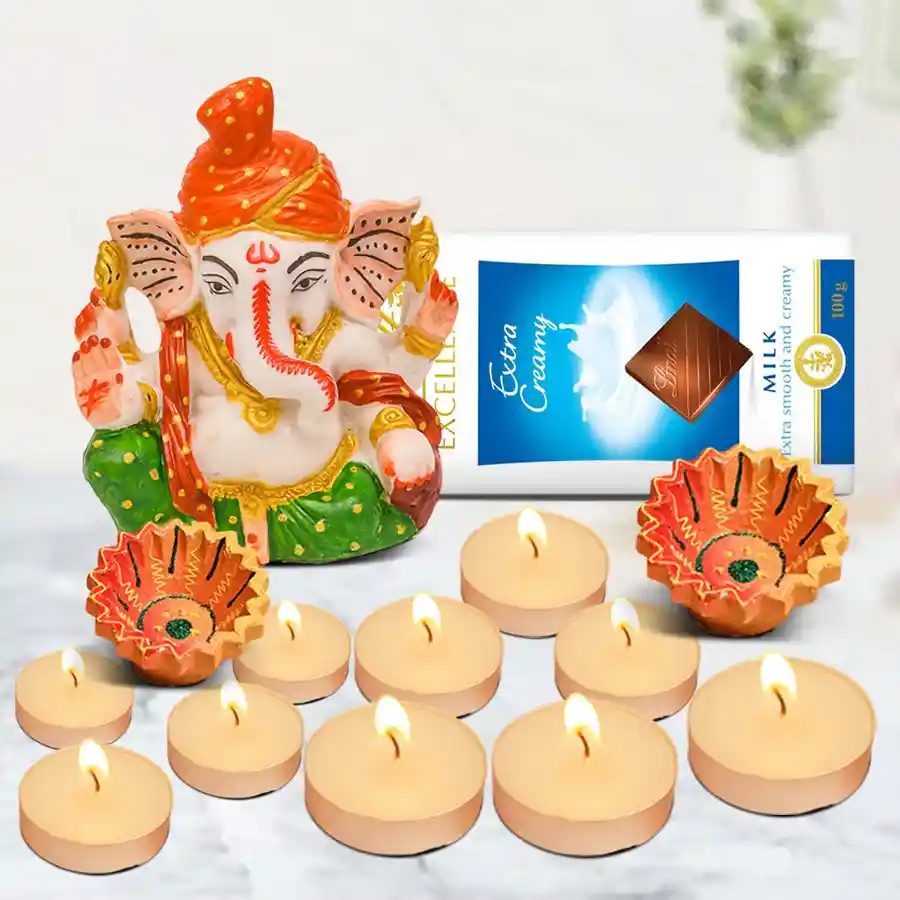 Stunning Diwali Chocolate and Gifts Hamper featuring a Ganesh idol, Lindt Excellence milk chocolate, scented T-light candles, and designer clay diyas.