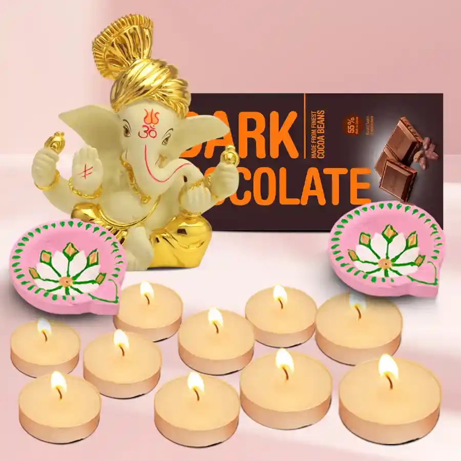 A beautifully arranged Diwali hamper featuring a Polyresin Pagdi Ganesh Idol, Amul Dark Chocolate, ten scented tea-light candles, and two designer clay diyas.