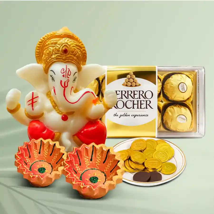 Opulent Festivities Hamper featuring designer clay diyas, a Polyresin Pagdi Ganesh Idol, Ferrero Rocher chocolates, and gold coin chocolates, all elegantly arranged for Diwali celebrations.