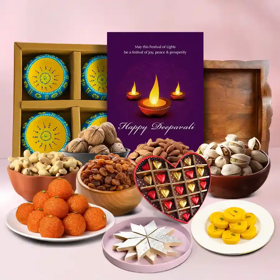 Diwali Delights hamper featuring sweets, nuts, clay diyas, a heart-shaped chocolate box, and a festive card on a decorative tray.