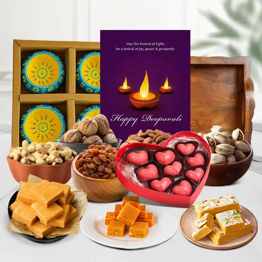 Luxurious Diwali Treats Gift Set featuring butter Scotch, orange fudge, mewa fudge bites, premium nuts, heart-shaped chocolate box, designer clay diyas, and a Happy Diwali card on a decorative tray.