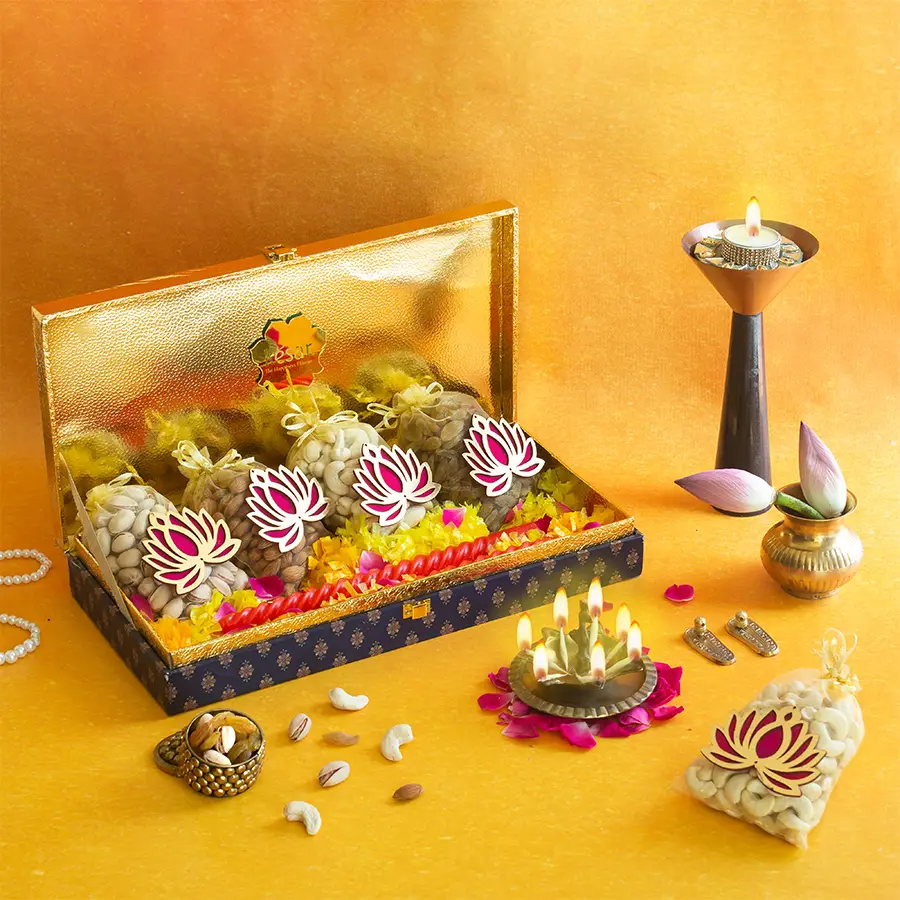 Premium Dry Fruit Box featuring almonds, cashews, raisins, pistachios, flowers, and a scented candle in a blue festive packaging