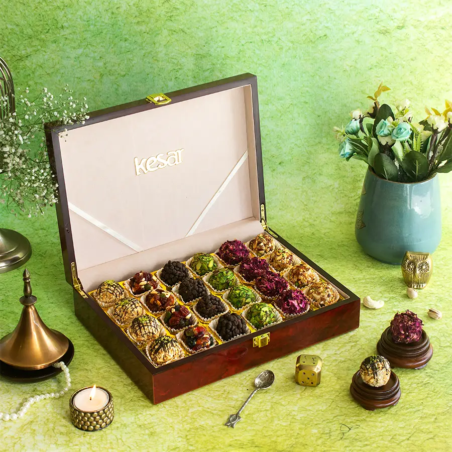 Luxurious Laddoo Assortment in a festive wooden lacquer gift box with six flavors displayed, featuring intricate mosaic details and a glossy finish.