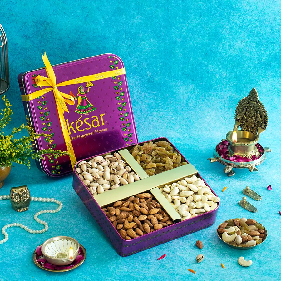 Diwali Nut Treasures Tin Box filled with creamy cashews, crunchy almonds, vibrant pistachios, and sweet raisins