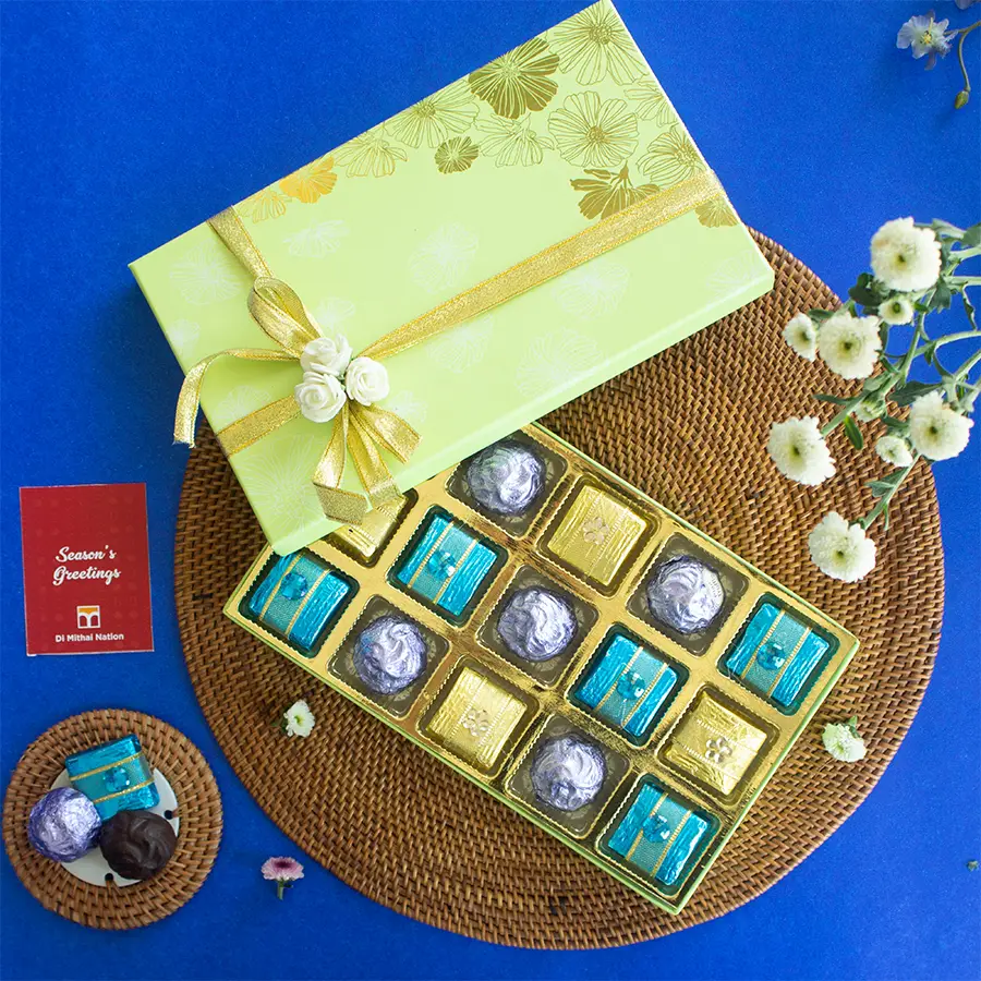 A beautifully arranged 15-piece collection of premium handmade chocolates in a green gift box.