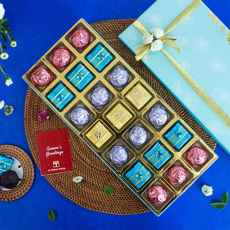 Elegant blue box containing 21 handcrafted premium chocolates in various shapes and flavors.