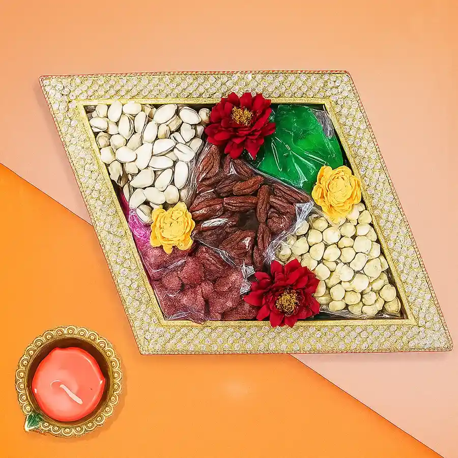 Fruity N Nutty Diwali Delights hamper with sparkling Diya, hazelnuts, kiwi, strawberries, pistachios, and pecannut arranged in an elegant Designer Pearl Tray