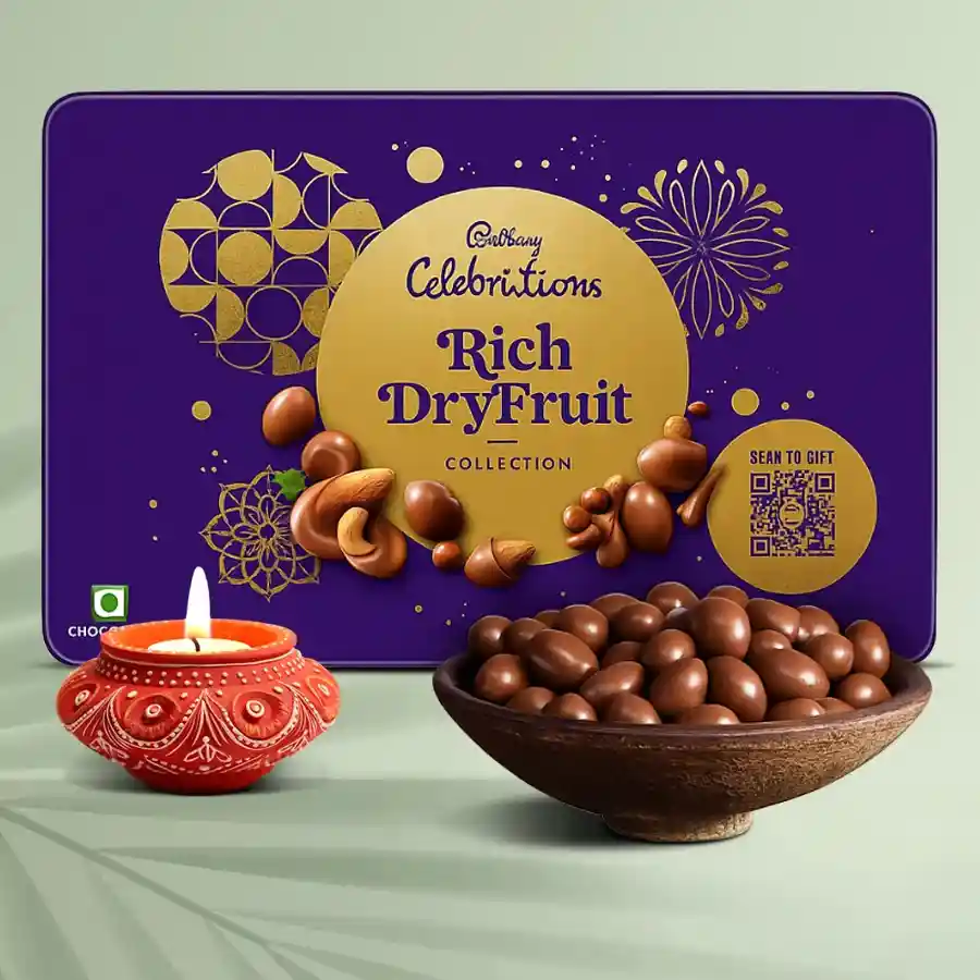 Diya N Chocs hamper featuring a handcrafted diya, a box of Cadbury Celebrations chocolates, and a collection of rich dry fruits, beautifully arranged for Diwali celebrations.