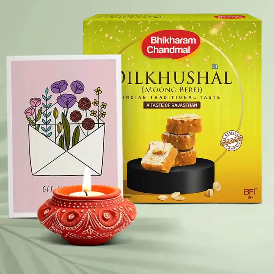 Festive Happiness Diya N Sweets hamper featuring a traditional Diya, 500g of Dil Khusal sweets, and a complimentary message card, all arranged beautifully for Diwali celebrations.